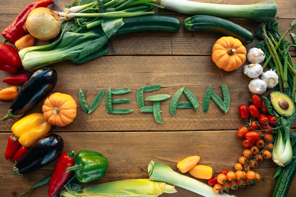 Illustrative stock photograph showing fresh vegetables arranged to spell the word vegan