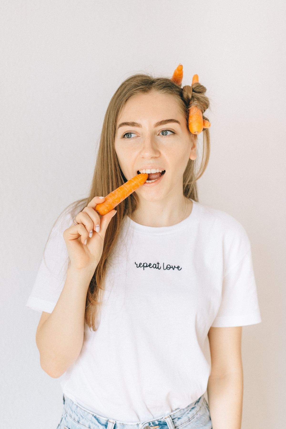 Illustrative stock photograph showing a person eating a fresh carrot