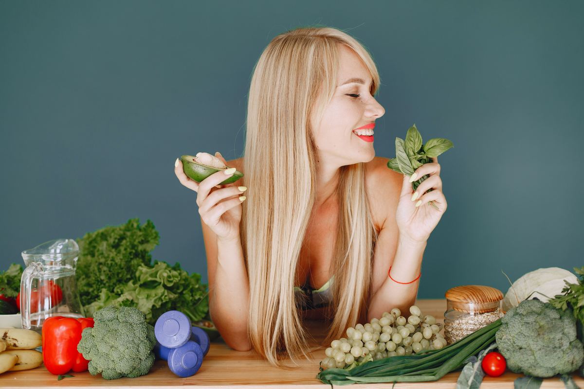 Illustrative stock photograph showing a person surrounded by fresh vegetables and produce
