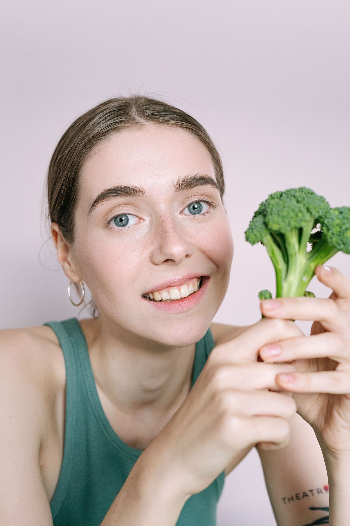Illustrative stock photograph of an adult holding broccoli