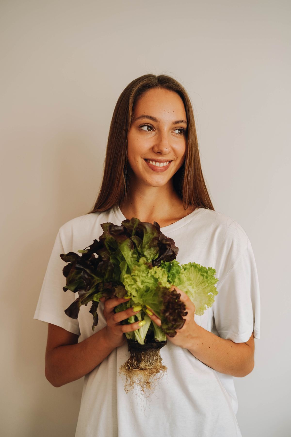 Illustrative stock photograph of an adult holding fresh lettuce
